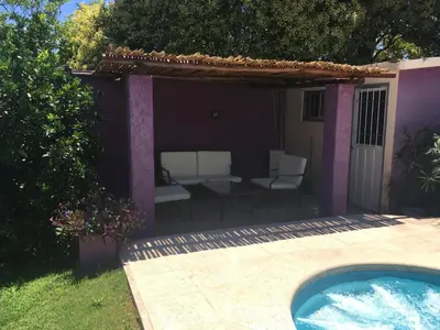a backyard with a hot tub and a pergola at Departamento Carlos paz in Villa Carlos Paz