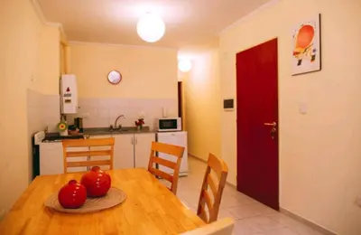 a kitchen with a wooden table with tomatoes on it at Tranquilo, comodo y cerca de todo in Cordoba