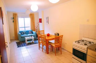 a kitchen and living room with a table and chairs at Tranquilo, comodo y cerca de todo in Cordoba