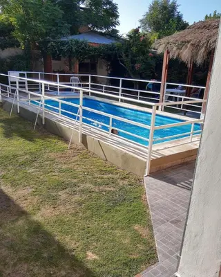 a swimming pool with a fence around it at Residencial Sol del Champaqui in Mina Clavero