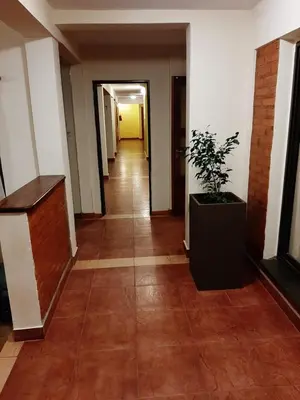 an empty hallway with a potted plant in a building at Residencial Sol del Champaqui in Mina Clavero