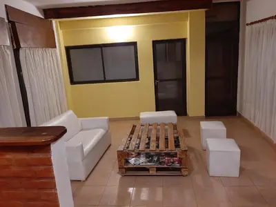 a living room with a couch and a table at Residencial Sol del Champaqui in Mina Clavero