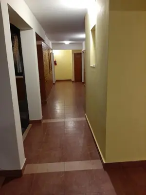 a hallway with yellow walls and a tile floor at Residencial Sol del Champaqui in Mina Clavero