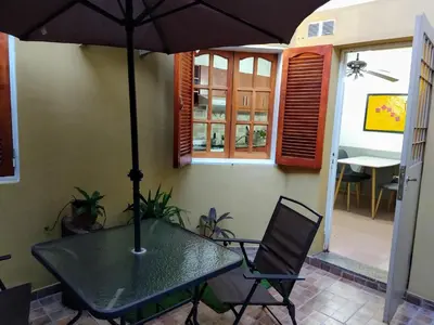 a table with an umbrella on a patio at De pasadita in Cordoba