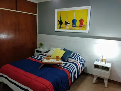 a bedroom with a bed with a table on it at De pasadita in Cordoba