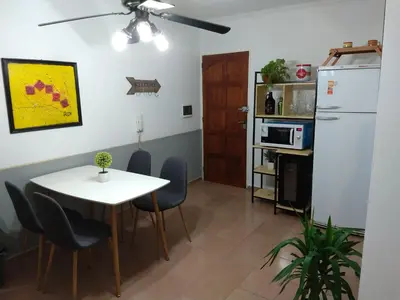a kitchen and dining room with a table and a refrigerator at De pasadita in Cordoba