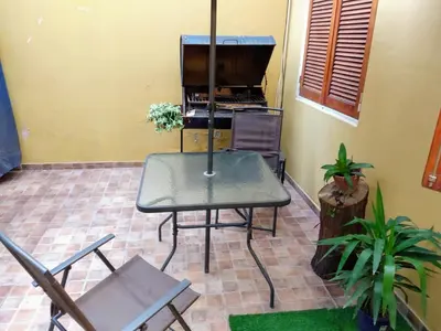 a table and chairs in a room with a piano at De pasadita in Cordoba