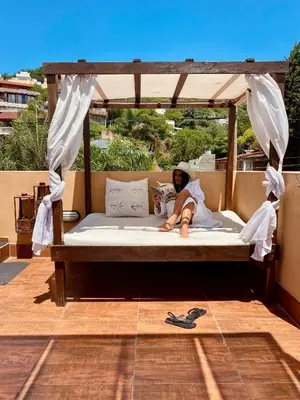 a man laying on a bed under a canopy at Rincón de Paz Apart & Loft Suite Boutique - Adults Only in Villa Carlos Paz