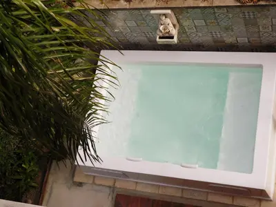 a swimming pool next to a plant at Rincón de Paz Apart & Loft Suite Boutique - Adults Only in Villa Carlos Paz