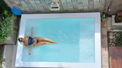 a man laying in a swimming pool at Rincón de Paz Apart & Loft Suite Boutique - Adults Only in Villa Carlos Paz