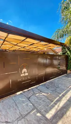 a brown train car sitting next to a sidewalk at Rincón de Paz Apart & Loft Suite Boutique - Adults Only in Villa Carlos Paz