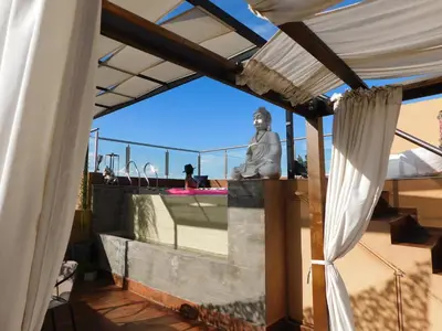 a statue sitting on top of a building with a roof at Rincón de Paz Apart & Loft Suite Boutique - Adults Only in Villa Carlos Paz