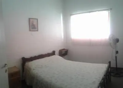 a bedroom with a bed and a window at Dptos LOW COST in Mina Clavero