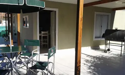 a patio with a table and chairs and a piano at Tu Casa en Villa General Belgrano Calamuchita Córdoba in Villa General Belgrano