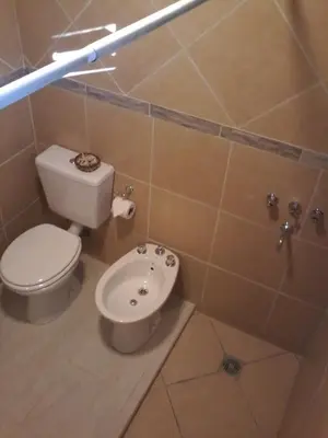 a bathroom with a toilet and a bidet at Tu Casa en Villa General Belgrano Calamuchita Córdoba in Villa General Belgrano