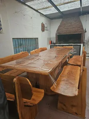 a large wooden table with benches in a room at Mi casa, equipada para el viajero y su familia in Cordoba