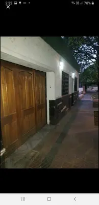 a building with two large wooden doors on it at Mi casa, equipada para el viajero y su familia in Cordoba