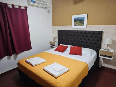a bedroom with a large bed with two towels on it at Mi casa, equipada para el viajero y su familia in Cordoba