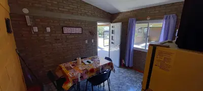 a room with a table with chairs and a window at Santa isabel in Embalse