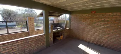 an empty room with a brick wall and windows at Santa isabel in Embalse