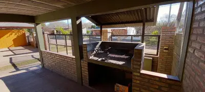 a patio with an outdoor grill in a building at Santa isabel in Embalse
