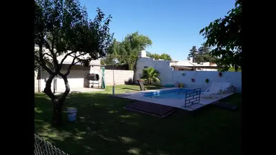 a yard with a swimming pool and a tree at Santa isabel in Embalse