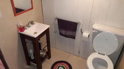 a small bathroom with a toilet and a sink at El Reencuentro in Los Reartes