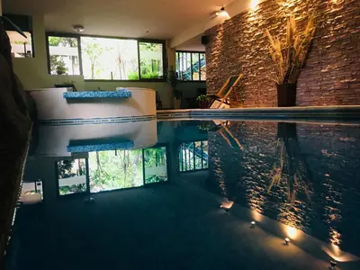 a pool with a tub in the middle of a house at Los Espinillos Hotel y Spa in Villa Carlos Paz