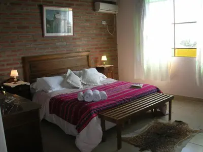 a bedroom with a bed with two towels on it at Posada Los Antiguos-Adults Only in Merlo