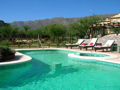 a swimming pool with lounge chairs and a swimming pool at Posada Los Antiguos-Adults Only in Merlo