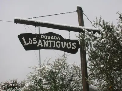 a sign for los angeles antiques hanging from a pole at Posada Los Antiguos-Adults Only in Merlo
