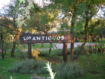 a sign that says us antiques in a park at Posada Los Antiguos-Adults Only in Merlo