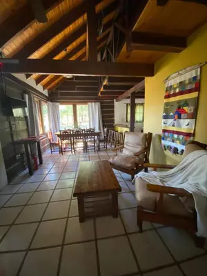 a living room with a couch and chairs and a table at Cabañas Los Maderos in Villa General Belgrano