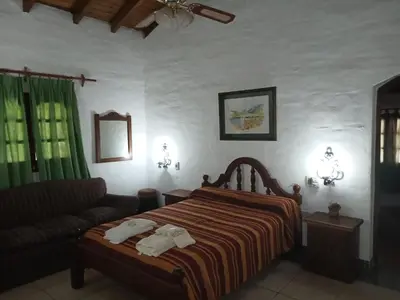 a bedroom with a bed and a couch at La Posta del Mistol in Las Tapias