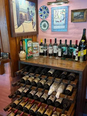 a bunch of bottles of wine on a shelf at La Posta del Mistol in Las Tapias