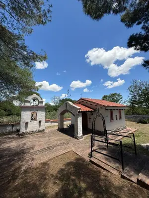 a playground in front of a building with a swing at La Posta del Mistol in Las Tapias