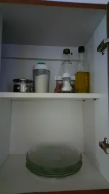 a shelf with a green lid in a kitchen at Apartamentos Santa Rosa PB 2 in Cordoba