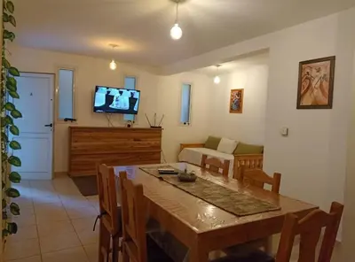 a living room with a dining room table and a television at Apartamentos Santa Rosa PB 2 in Cordoba