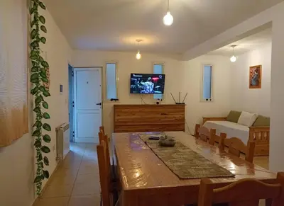 a living room with a table and a bed and a television at Apartamentos Santa Rosa PB 2 in Cordoba