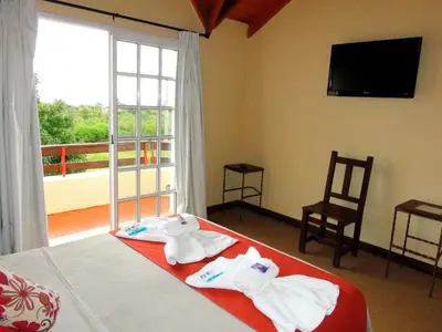a bedroom with a bed with towels on it at Posada del Tiempo in Merlo