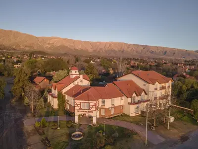 an aerial view of a large house with mountains in the background at Posada del Tiempo in Merlo