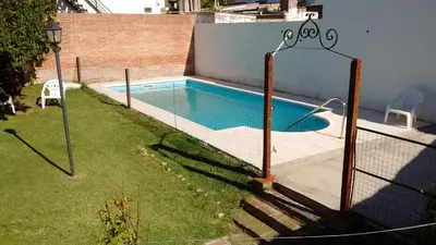 a swimming pool with a fence around it at HOSTERIA NIDO DE CONDORES-Solo Adultos in Mina Clavero