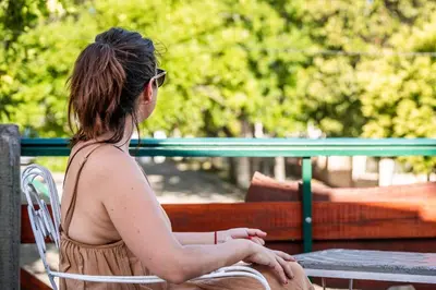 a woman sitting on a park bench at HOSTERIA NIDO DE CONDORES-Solo Adultos in Mina Clavero