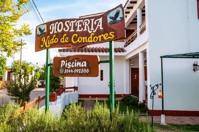 a sign for a restaurant in front of a building at HOSTERIA NIDO DE CONDORES-Solo Adultos in Mina Clavero