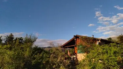 an old house sitting in the middle of a field at Al Encuentro Casas de Montaña in Nono