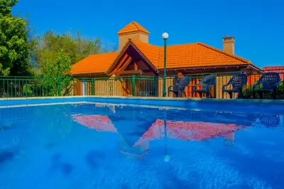 a house with an orange roof and a swimming pool at Complejo Vip Houses in Merlo