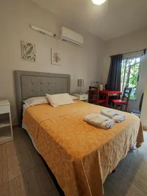 a bedroom with a bed with two towels on it at La Caballeriza habitación doble in Alta Gracia