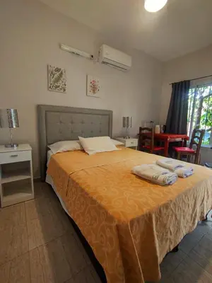 a bedroom with a bed with two towels on it at La Caballeriza habitación doble in Alta Gracia