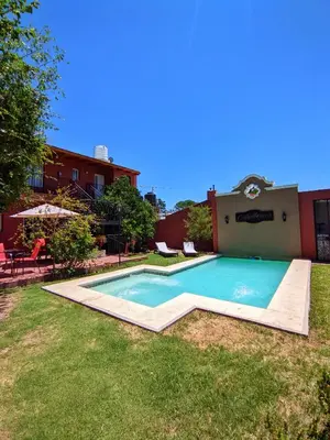 a swimming pool in the yard of a house at La Caballeriza habitación doble in Alta Gracia