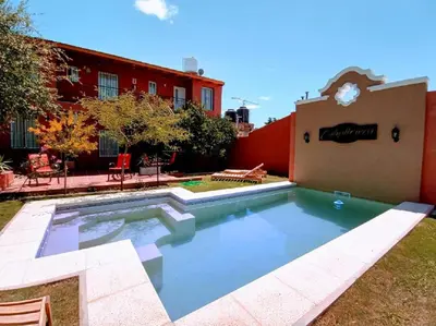 a swimming pool in the yard of a building at La Caballeriza habitación doble in Alta Gracia
